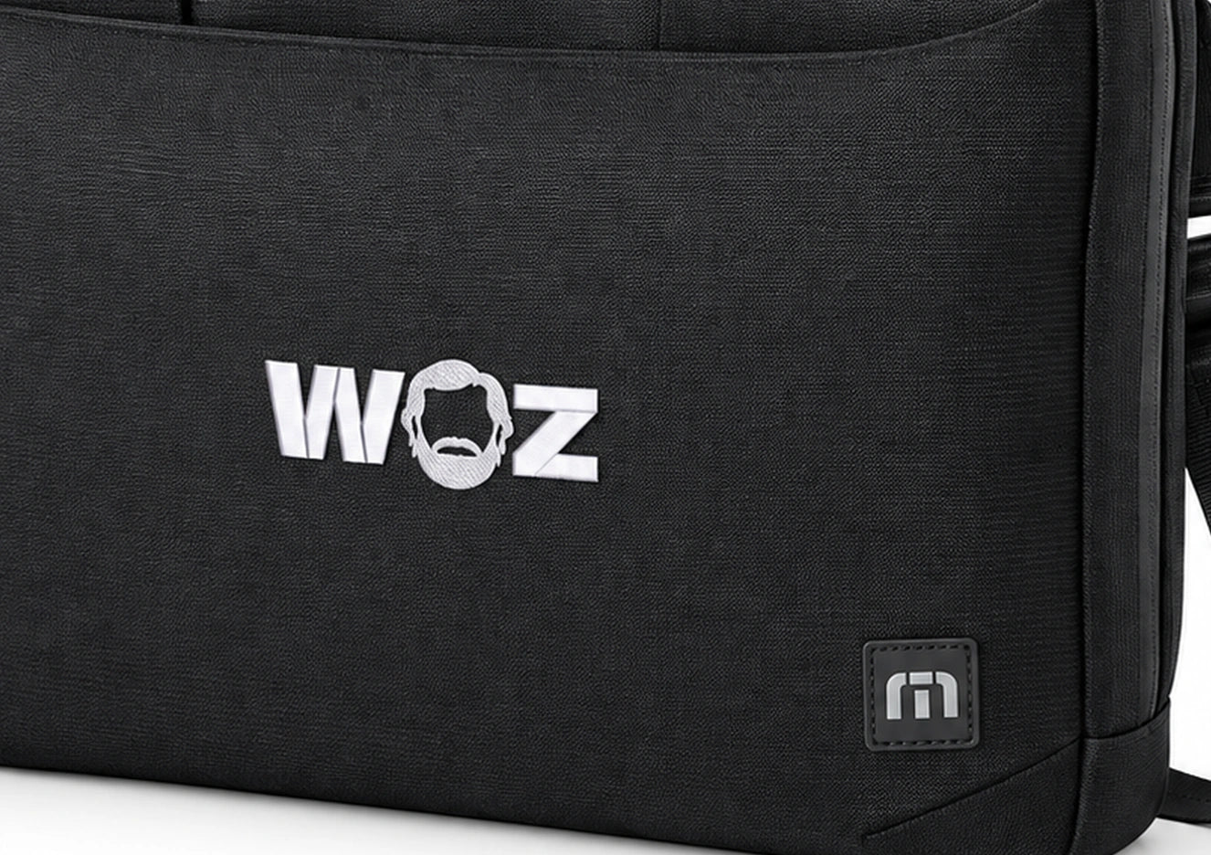WOZ x TravisMathew Lateral Briefcase - front artwork and lower bag, cropped from the existing catalog image.