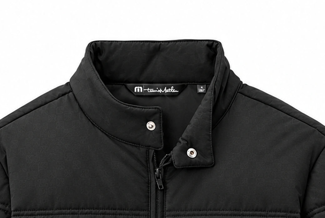 WOZ × TravisMathew Cold Bay Jacket - collar and fasteners, cropped from the existing catalog image.