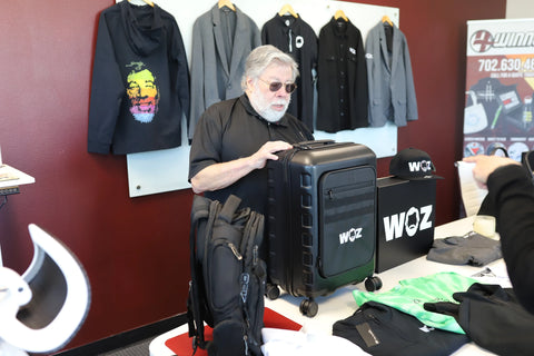 Woz examining WOZ-branded luggage.