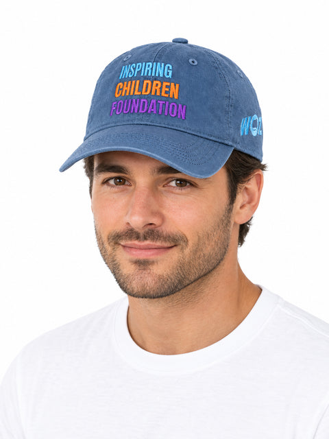 Adult male model wearing the updated blue WOZ × ICF cap on a white background.